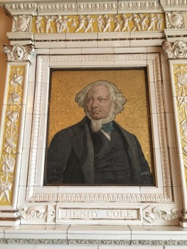 Ceramic plaque with a portrait of Henry Cole, a white man with white hair in a 19th century suit 
